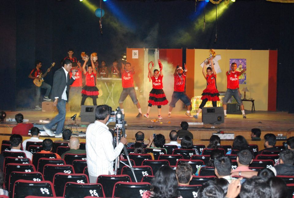 On-stage band with a dancer in a green dress on the right