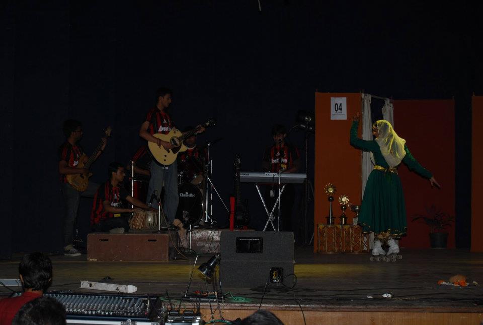 The wheelchair-bound football player onstage with the band behind
