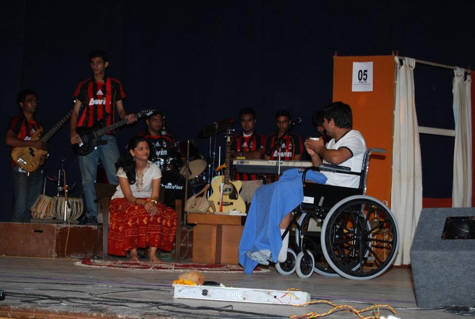 Full cast performing on stage with visible audience